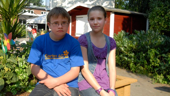 Matteo (Robin Huth) und Nina (Carolin Garnier) sitzen vor einem Gartenhaus © NDR/Romano Ruhnau 