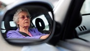 Eine ältere Dame stellt den Seitenspiegel im Auto ein. © picture alliance / dpa | Alexander Körner Foto: Alexander Körner