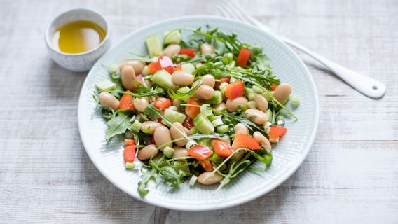 Ein Teller mit Bohnensalat steht auf einem Tisch. © NDR Foto: Claudia Timmann