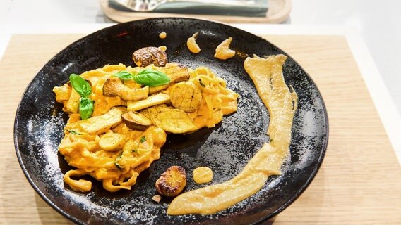 Fettuccine mit Paprikasoße und Kräuterseitlingen auf einem Teller angerichtet. © NDR / Fernsehmacher GmbH Foto: Gunnar Nicolaus