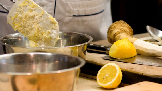 Johann Lafer vermischt Zitronenschale und Buttermasse in einem Topf © NDR Foto: Claudia Timmann