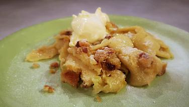 Ein zerkleinerter Pfannkuchen mit Stollen liegt auf einem grünen Teller. © NDR 