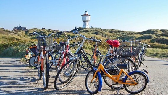 Fahrräder stehen in den Dünen vorm Wasserturm auf Langeoog © www.ostfriesland.de 