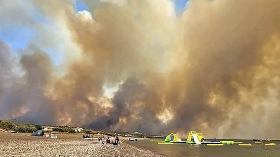Rauchwolken eines Waldbrandes steigen auf der griechischen Insel Rhodos in den Himmel © uncredited/Rhodes.Rodos/AP/dpa 