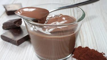 Ein Schokoladenpudding in einer Glasschale mit einem Löffel und echten Schokoladenstückchen. © fotolia.com Foto: Ally