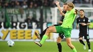 Wolfsburgs Sebastiaan Bornauw (vorne) und Bremens Marvin Ducksch kämpfen um den Ball. © picture alliance/dpa | Swen Pförtner 