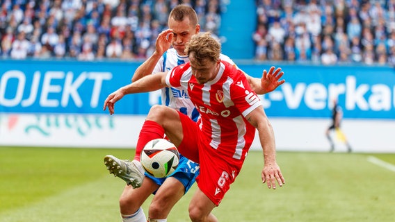 Rostocks Franz Pfanne (hinten) und Jonas Hofmann (Energie Cottbus) kämpfen um den Ball. © IMAGO / Andy Bünning 