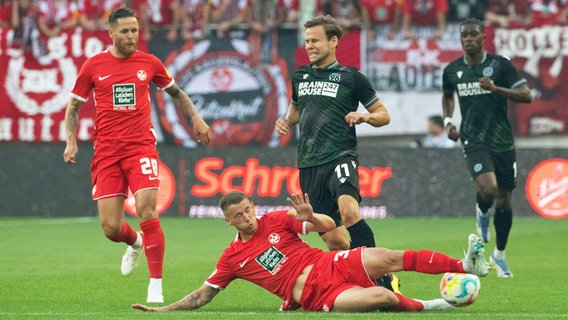 Kaiserslauterns Erik Durm grätscht Hannovers Louis Schaub den Ball weg. © IMAGO / Hübner 