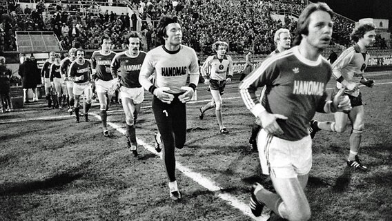 Die Mannschaften von Hannover 96 (vorne) und Eintracht Braunschweig laufen am 20. März 1981 im Eintracht-Stadion ein. © Fritz Rust Foto: Fritz Rust