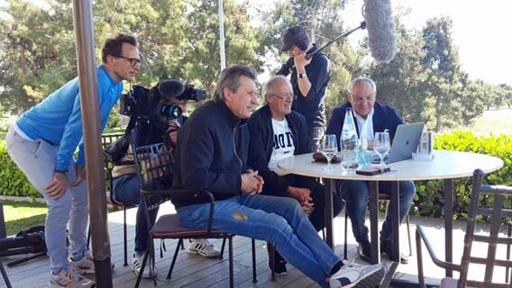 Die HSV-Legenden Manfred Kaltz, Bernd Wehmeyer und Felix Magath (v.l.) in Athen mit NDR Reporter Michael Maske (l.) © NDR 