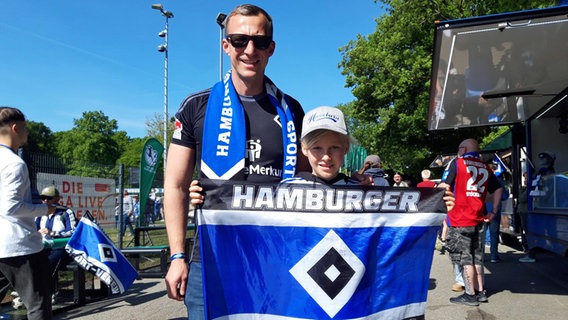 Ein Mann und seine Tochter mit HSV-Fanschal und HSV-Fahne. © NDR.de Foto: Florian Neuhauss