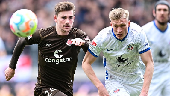 Connor Metcalfe (a sinistra) dell'FC St. Pauli duella con Kevin Schumacher dell'FC Hansa Rostock © Witers 