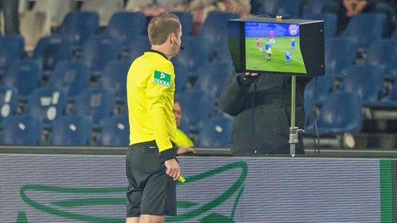 Schiedsrichter Martin Thomsen prüft am Monitor den Videobeweis zu einer Spielszene. © imago images Foto: imago images / Sven Simon