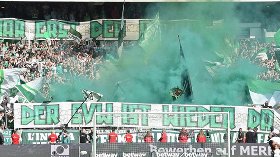 Fans von Werder Bremen zünden bei einem Heimspiel grüne Pyrotechnik. © Witters 