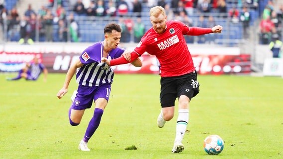 Hannovers Torschütze Sebastian Kerk (r.) und Aues Nicolas-Gerrit Kühn kämpfen um den Ball. © IMAGO / Picture Point 