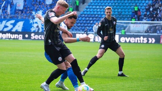 Rostocks Kevin Schumacher (l.) und Magdeburgs Herbert Bockhorn kämpfen um den Ball. © IMAGO / Eibner 