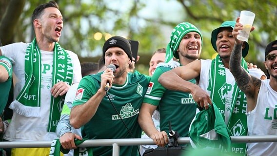 Bremens Spieler um Niclas Füllkrug (2.v.l.) lassen sich für den Aufstieg in die Bundesliga auf einem Truck von den Fans feiern. © IMAGO / Kirchner-Media 