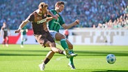 Bremens Niklas Stark (r.) und St. Paulis Carlo Boukhalfa kämpfen um den Ball. © Witters/LeonieHorky 