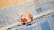 Ein Handball liegt im Tornetz. © picture-alliance Foto: Frank Hoermann / Sven Simon