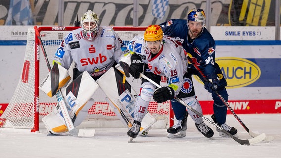 Bremerhavens Maximilian Franzreb (l.) und Gregory Kreutzer (M.) verteidigen gegen Münchens Maximilian Kastner © IMAGO / Eibner 