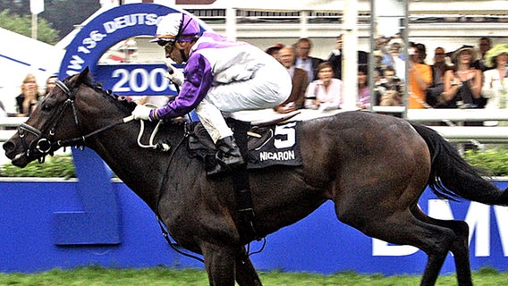 Jockey Davy Bonilla gewinnt in Hamburg-Horn auf Nicaron das Deutsche Derby. © dpa Foto: Ulrich Perrey