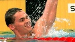 Der Schwimmer Alexander Popow (RUS) jubelt über den Gewinn der Goldmedaille im 100 Meter Freistil-Finale. © picture-alliance / dpa