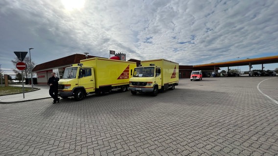 Zwei gelbe Lastwagen halten vor einer Tankstelle © Feuerwehr Hamburg 
