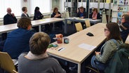 Vielen Menschen der AG Sprache und Literatur im Nordfriisk Instituut sitzen im Tischkreis © NDR Foto: Meike Riewerts
