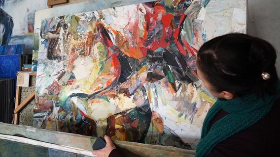 Dorle Bahlburg schaut auf Gemälde im Gadendorfer Krug © NDR Foto: Samir Chawki