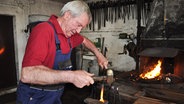 Hans Henning Holm bei der Arbeit in seiner Schmiede. © NDR Foto: Peter Bartelt