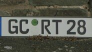 Eine Autokennzeichen mit: GC-RT-28.  