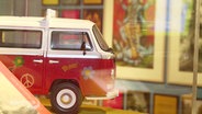 Ein verzierter Miniatur-Bus von Volkswagen. © Screenshot 