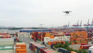 Über einem Containerterminal im Hamburger Hafen schwebt eine Drohne. © Screenshot 