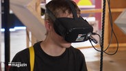 Ein junger Mann trägt eine VR-Brille. © Screenshot 