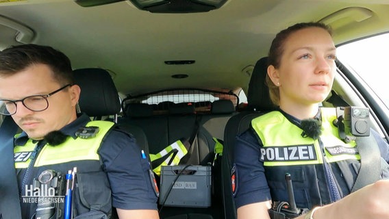 Ein Polizist und eine Polizistein im Streifenwagen. © Screenshot 