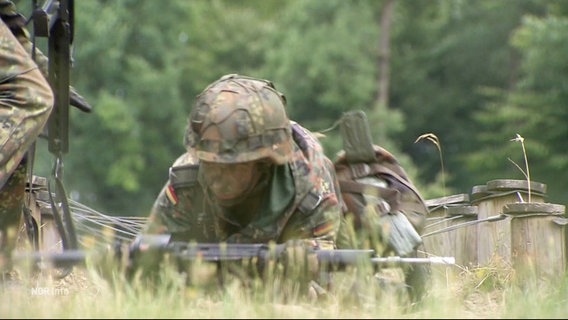 Ein Soldat im hohen Gras beim Kriechen. © Screenshot 