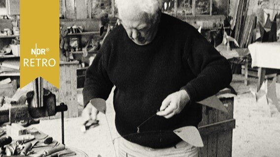 Alexander Calder in seinem Atelier in Paris bei der Arbeit an einem Mobile (1965)  