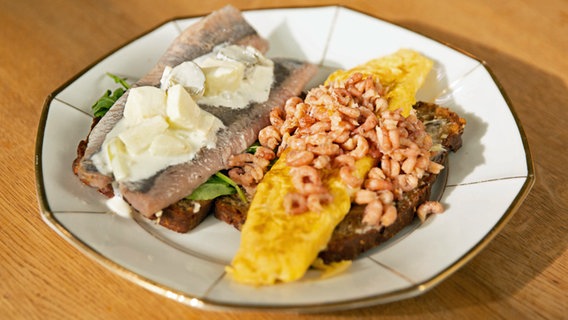 Matjes und Krabben-Omelett auf Schwarzbrot auf einem Teller serviert. © NDR/Doclights GmbH 