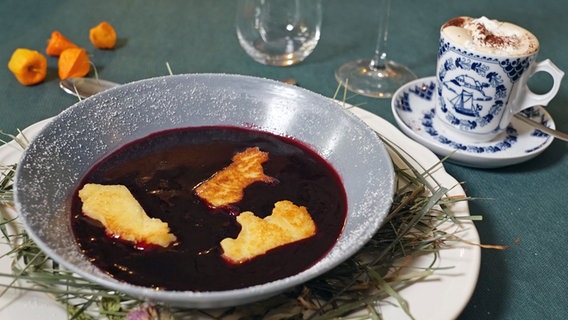 Fliederbeersuppe mit Grießklößchen in einem tiefen Teller serviert. © megaherz 