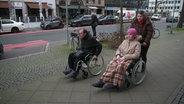 Svitlana, Yuri und Tochter Kira aus Charkiv werden in Deutschland behandelt. Vater und Tochter sitzen im Rollstuhl. © NDR 