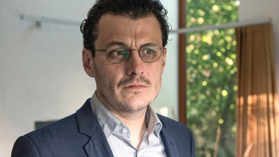 Ein Mann mit Brille und Oberlippenbart schaut nachdenklich vor sich hin © SWR/Alexander Kluge Foto: Alexander Kluge