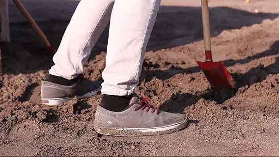 John Goetz buddelt im Sand © NDR 