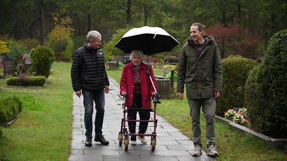 Elfriede Berkhahn aus Ramlingen mit zwei ihrer Familienangehörigen bei einem Friedhofs-Spaziergang. © NDR 