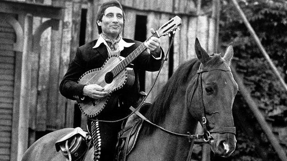 Hoch zu Ross spielt und singt Freddy Quinn 1976 bei der Premiere der Karl-May-Festspiele in Bad Segeberg. © picture-alliance / dpa 