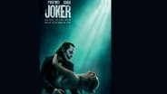 Joaquin Phoenix als Arthur Fleck (Joker) mit Lady Gaga - Szene aus dem Film "Joker  - folie á deux" © Warner Bros. GmbH 