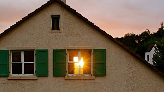 Die Sonne scheint durch ein geöffnetes Fenster in einem alten Haus. © Photocase Foto: Caoimhin22