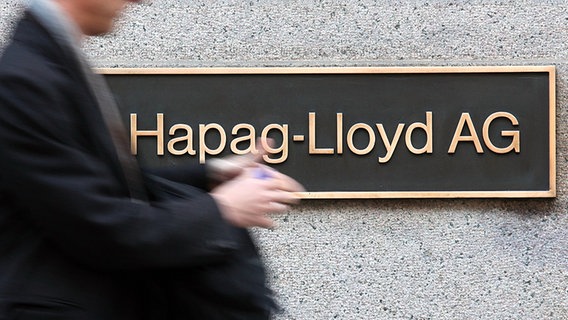 Ein Passant geht am Hapag-Lloyd-Stammsitz in Hamburg vorbei. © dpa Foto: Bodo Marks
