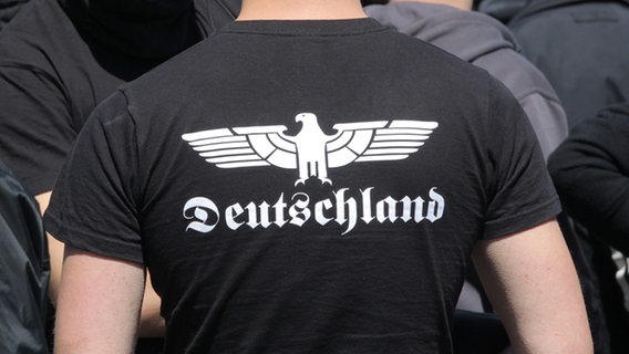 Ein Neonazi trägt ein T-Shirt mit dem Aufdruck "Deutschland" in gebrochener Schriftart. © picture alliance Foto: Markus Scholz