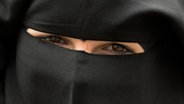 Eine Frau trägt einen Niqab. © Boris Roessler/dpa 