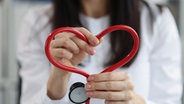 Eine Ärztin hält ein Stethoskop in Herzform hoch © Colourbox Foto: #257659